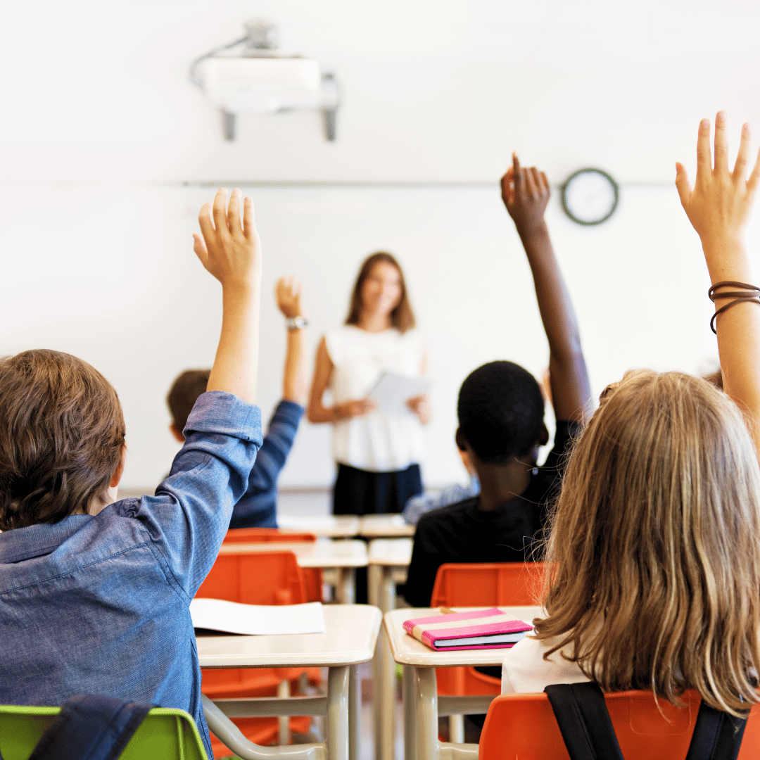 Classroom students raising hands