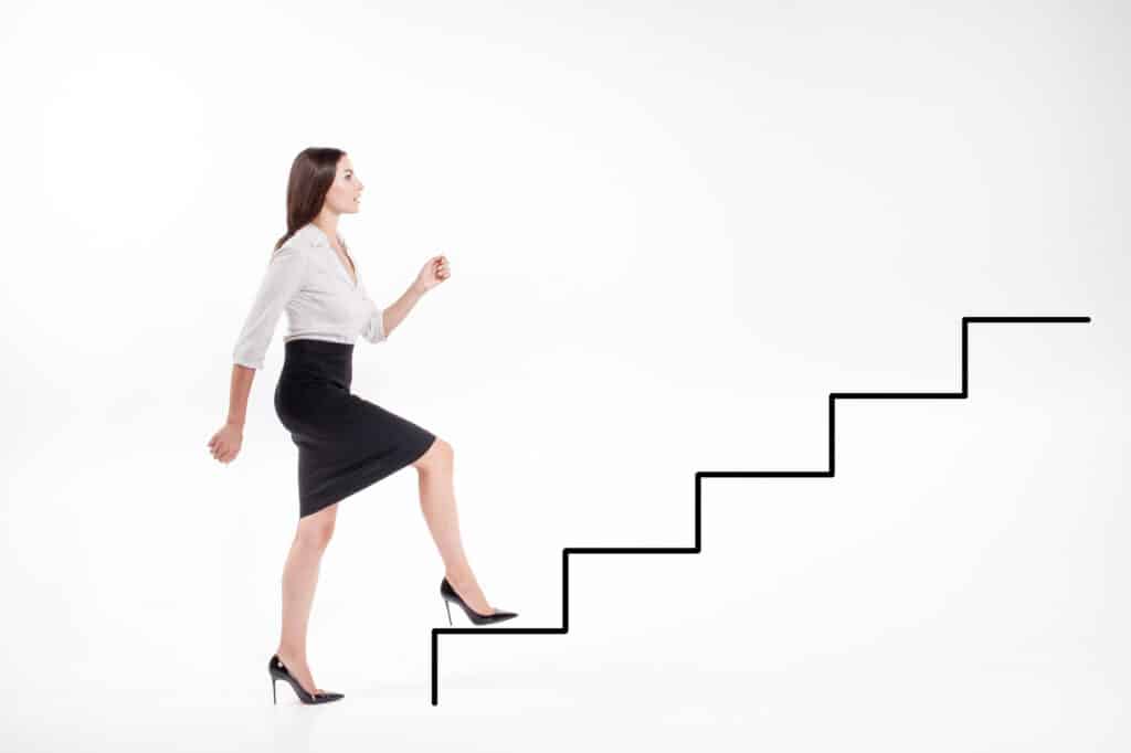business woman walking up illustrated steps